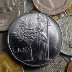 Moneta da 100 Lire con centenario, esposta su sfondo neutro, simbolo di valore collezionistico.